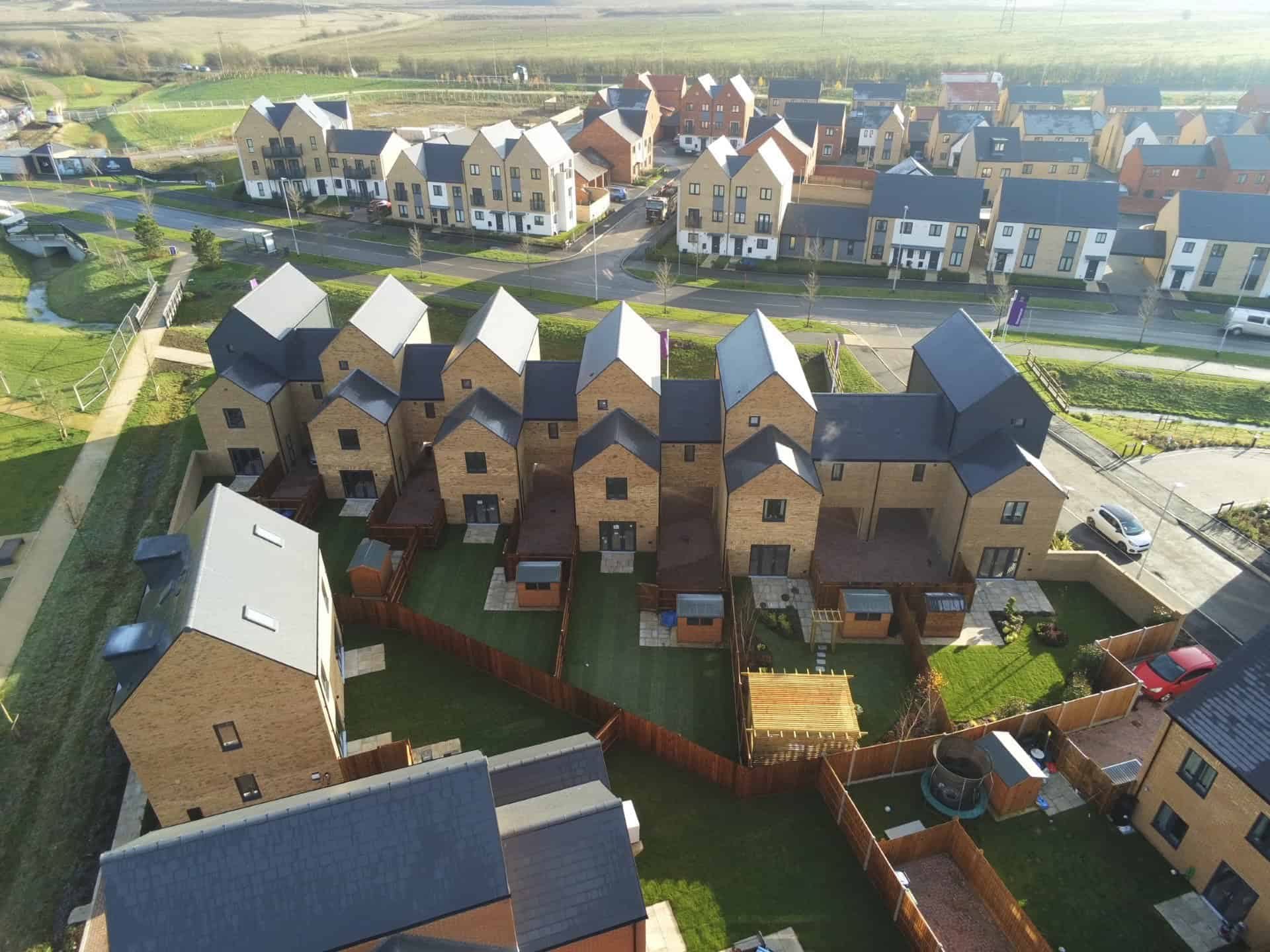 Aerial view of new build terraced homes and gardens at Wintringham