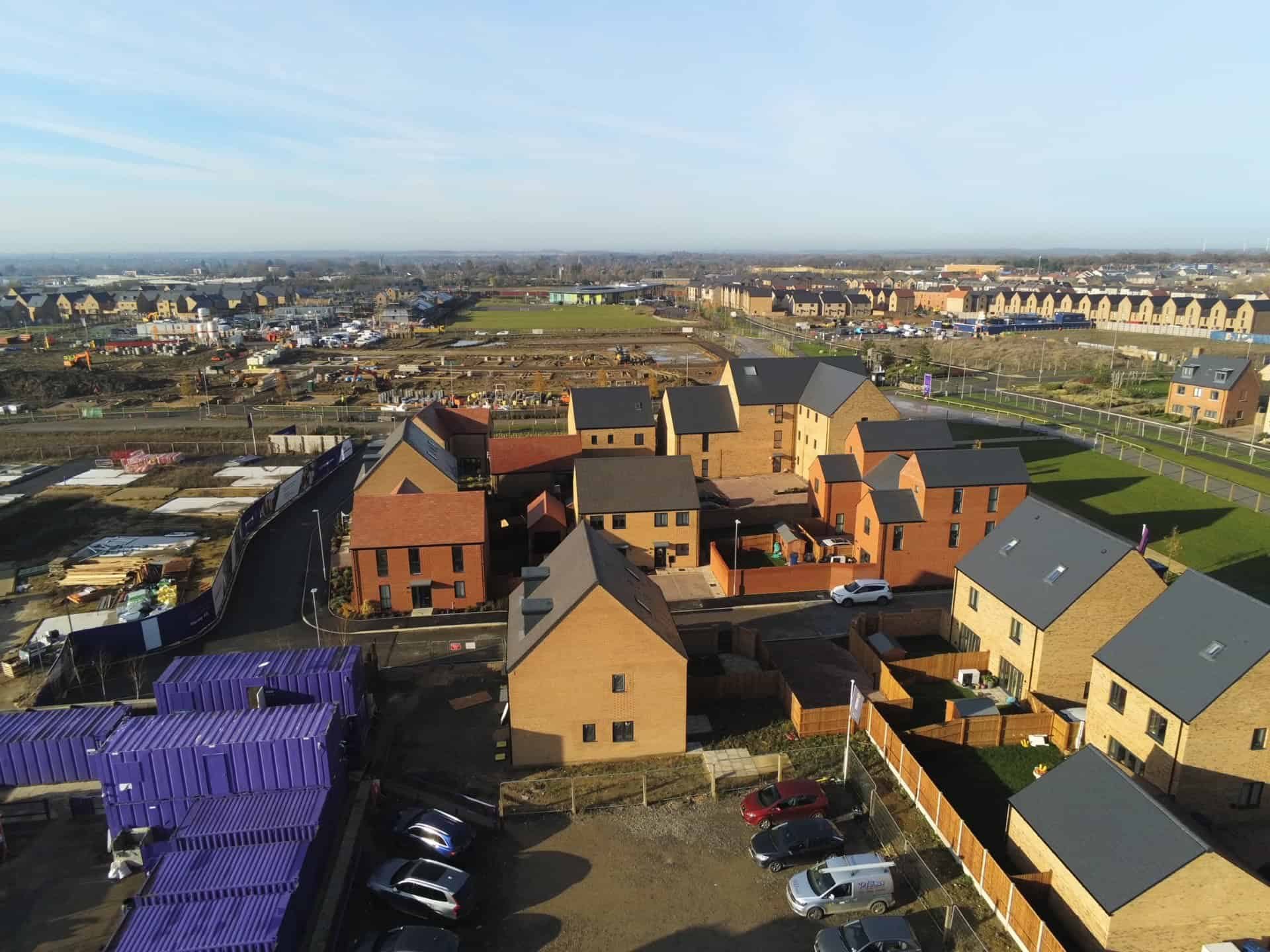 Aerial view of new build homes and site materials at Stamford