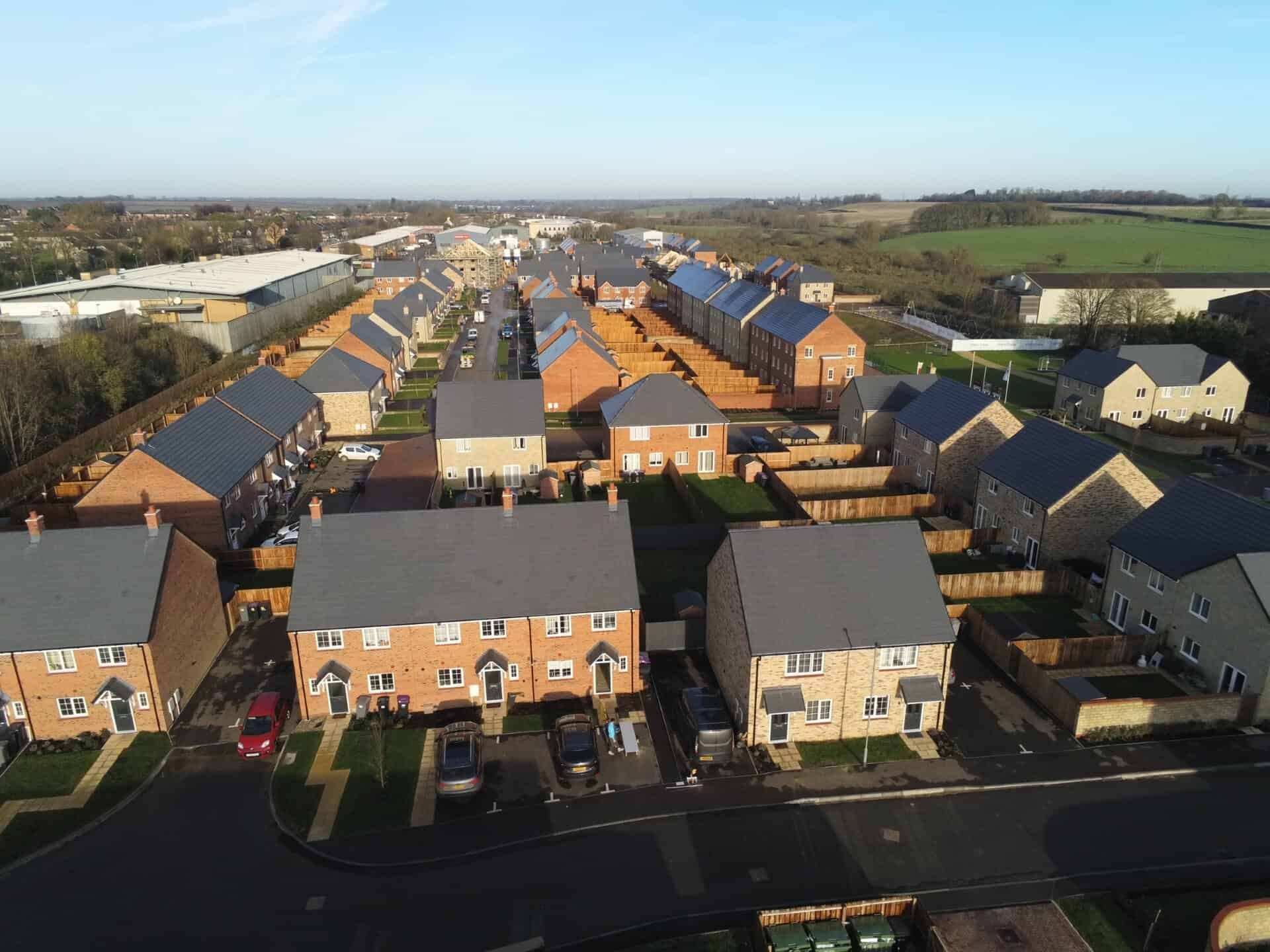 Aerial view of rows of new build terraced homes at Stamford